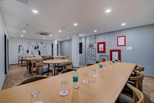a conference room with wooden tables and chairs at Super Townhouse T Nagar Chennai in Chennai