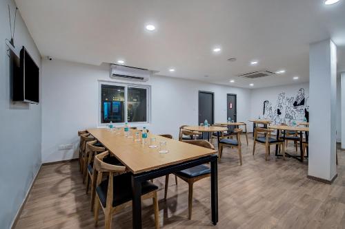 a row of tables and chairs in a room at Super Townhouse T Nagar Chennai in Chennai