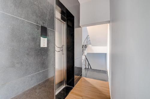 a hallway with a glass door and a staircase at Super Townhouse T Nagar Chennai in Chennai