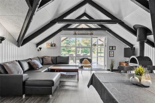a living room with a couch and a table at HA194-Hals-Sdr-Smalbyvej-25 in Hals