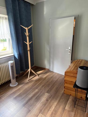 a room with a wooden cross on the floor and a door at GraueMaus in Asendorf