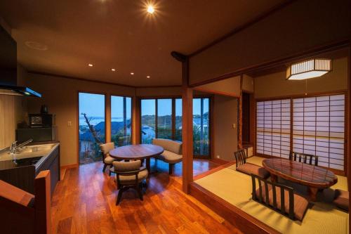 a kitchen with a table and chairs in a room at Beppu Kura in Beppu