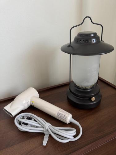 a blender and a white cord next to a lamp at Blue Moon House in Tawau