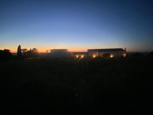 a group of semi trucks in a field at sunset at Dimora Filippo in SantʼElpidio a Mare