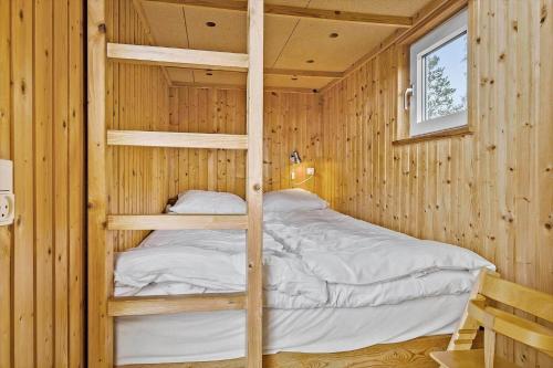 a bedroom with two bunk beds in a wooden cabin at OH253-Hadsund-Halvrebene-37 in Hadsund