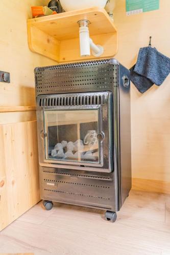a stove in a kitchen with toys inside of it at Bois aux Cheirilles - 15min Murol - Puy de Dome in Saint-Diéry