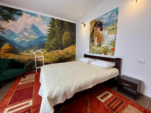 a bedroom with a painting on the wall at The Selo in Korostovat