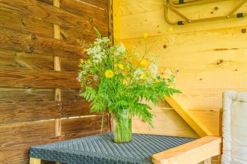 a vase filled with flowers sitting on a table at Bois aux Cheirilles - 15min Murol - Puy de Dome in Saint-Diéry