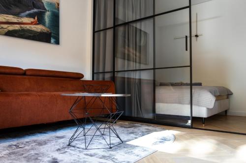 a living room with a couch and a table at SongInn Lake Apartment in Zarasai