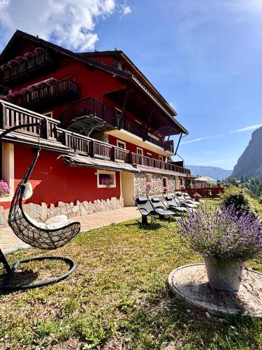 a building with a bunch of benches in front of it at Hotel Piccolo Chalet in Claviere