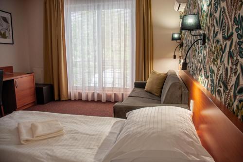 Postel nebo postele na pokoji v ubytování Wellness Hotel Thermal