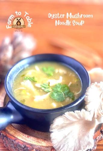 a blue bowl of soup on a plate with a flower at MeenaBagh Villa Rooms & Cafe in Shimla