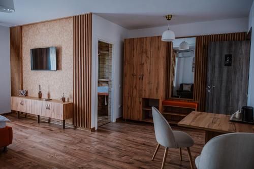 a living room with a table and a dining room at La Pădure 