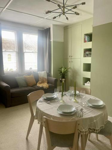 a living room with a table and a couch at Bridge House in Broadwater