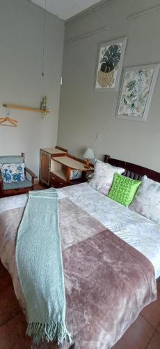 a bedroom with a large bed with a blanket on it at Oceanic Flashpackers accommodation in East London