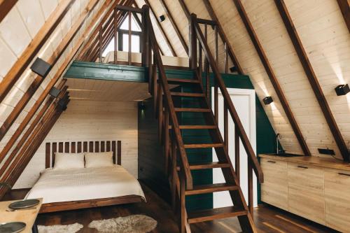 a bedroom with a bed and a staircase at Dravis Event Park 