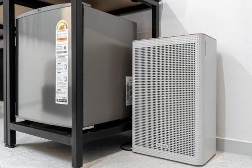 a metal radiator sitting next to a wall at EGSTAY HOTEl in Gwangju