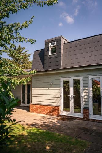 a house with a window on the side of it at Garden Villa in Cambridge