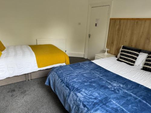 two beds sitting next to each other in a bedroom at Family Room 1 in Avonmouth