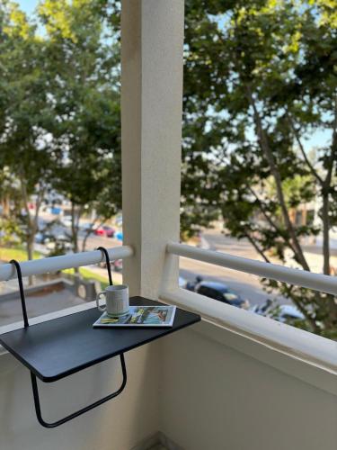 a small black table on a balcony with a coffee cup at Luxury apartments Alamos beach Torremolinos - Costa Lago in Torremolinos