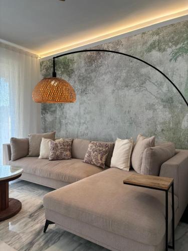 a living room with a couch and a wall at Luxury apartments Alamos beach Torremolinos - Costa Lago in Torremolinos