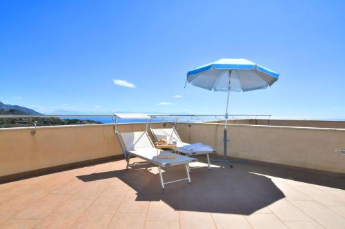 a chair and an umbrella on a roof at Villa La Meraviglia - Between Sorrento & Amalfi Coast in Colli di Fontanelle
