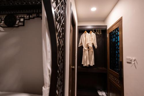 a dressing room with a robe hanging on a door at Soultel โซลเทล in Khlong San