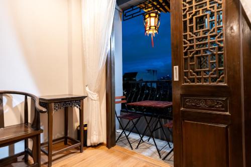 a room with a balcony with a table and a door at Soultel โซลเทล in Khlong San