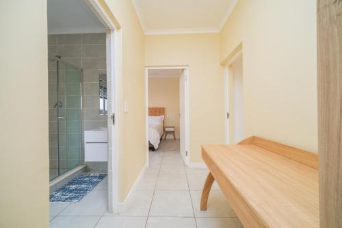 a bathroom with a shower and a wooden table at Ballito Hills 1153 in Ballito