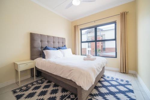 a bedroom with a large bed with a window at Ballito Hills 1153 in Ballito