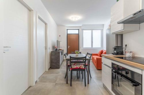 a kitchen and living room with a table and chairs at Dany & Carol - Affitto Breve Rho Stazione-Milano in Rho