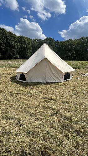a tent in a field of dry grass at Fredericksburg PA Farm Stay 