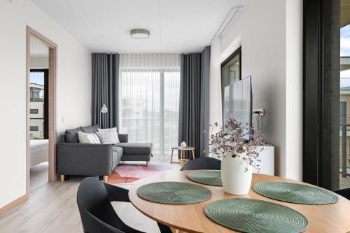 a living room with a wooden table and chairs at Top View Apartment Haapsalu in Haapsalu