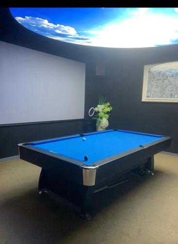 a blue pool table in a room with a ceiling at Beijing city center - Cosy family suite with city view in Beijing