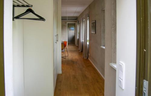 a hallway with a long hall with a hallway at Nice Apartment In Saltsjö Boo With House A Panoramic View in Kummelnäs