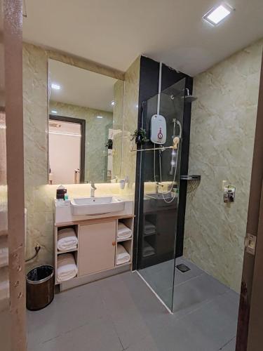 a bathroom with a sink and a shower at Suasana Suites Johor Bahru City Centre in Johor Bahru