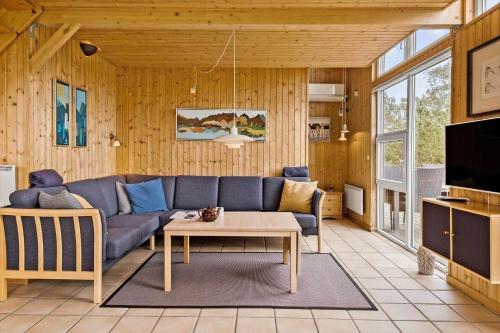 a living room with a blue couch and a table at OH253-Hadsund-Halvrebene-37 in Hadsund
