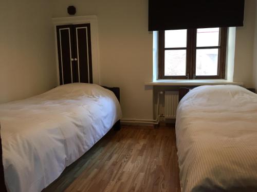 a bedroom with two beds and a window at Mohri Old Town Apartments in Pärnu