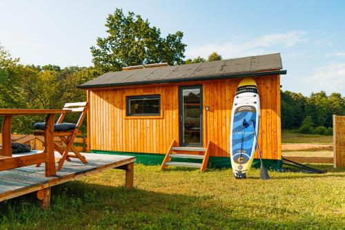 a small wooden house with a boat in it at Bull-Barn glamping in Liberec