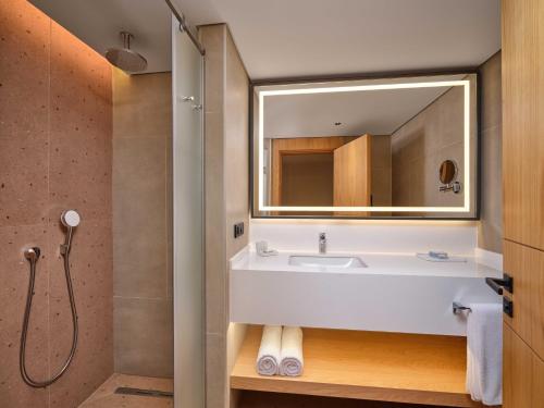 a bathroom with a white sink and a mirror at Paloma Grida in Belek
