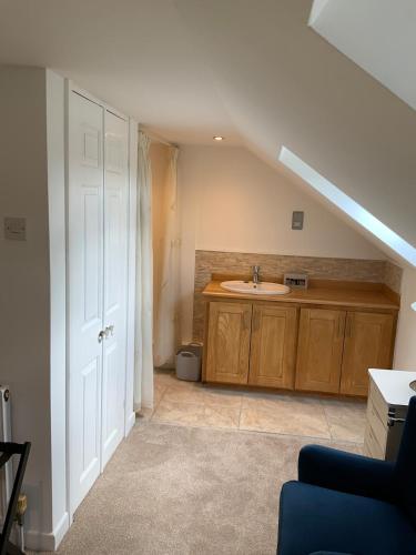 an attic bathroom with a sink and a sink at Oak Cottage - an inclusive peaceful haven in Newport