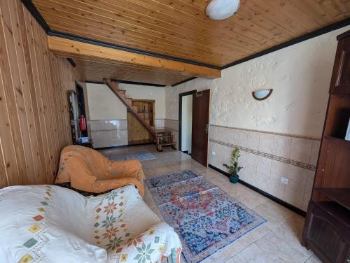 a bedroom with a bed and a wooden ceiling at Janela da Aldeia in Lomba
