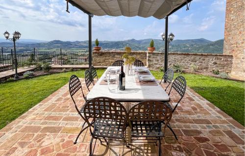 a table and chairs sitting on a patio at Lovely Apartment In Civitella Benazzone in Civitella Benazzone