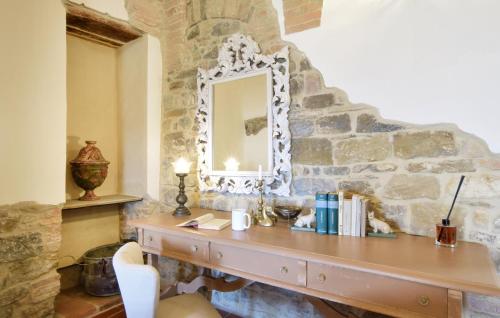 a stone wall with a vanity with a mirror at Lovely Apartment In Civitella Benazzone in Civitella Benazzone