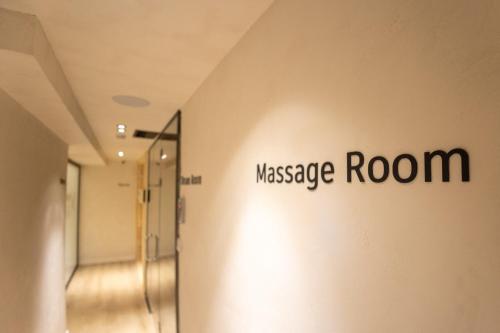 a hallway with a massage room sign on the wall at Saint Nicolas Hotel in Himare