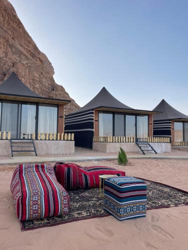 a group of pillows on the ground in front of a house at Wadi Rum, Hala bubbles in Wadi Rum