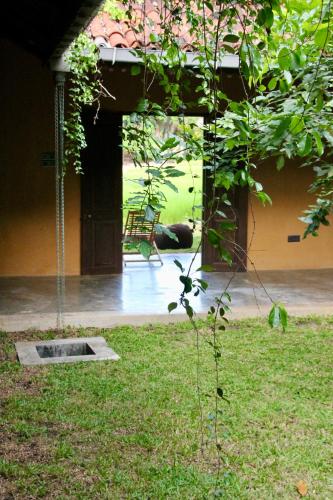 a view of a house with a swing in a yard at Village Verandah by Oshi in Dambulla