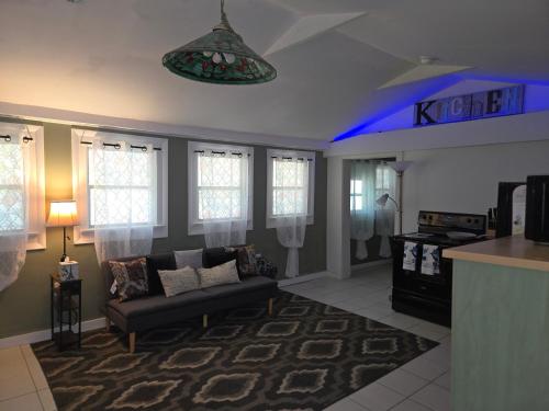 a living room with a couch and a table at Midtown Guesthouse in Mobile