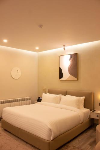 a bedroom with a large white bed in it at Zesora Nathia Gali in Nathia Gali