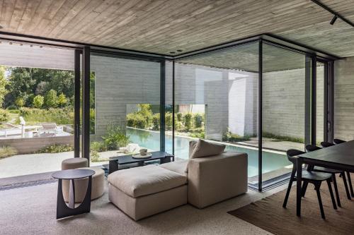 a living room with a couch and a table at Tranquil Designer Stay with Infinity Pool in Merchtem